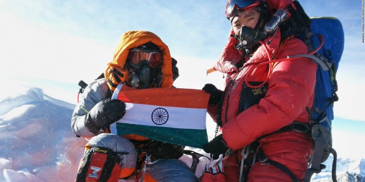 Malavath Poorna, left, holds