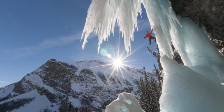 A man ice climbing a newly